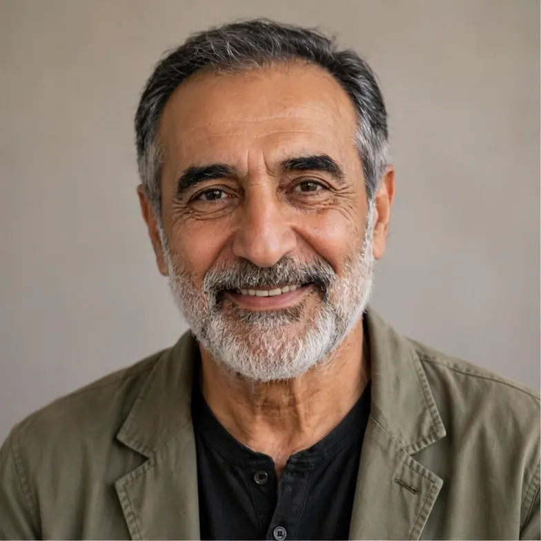Portrait of an older man with a gray beard and kind eyes